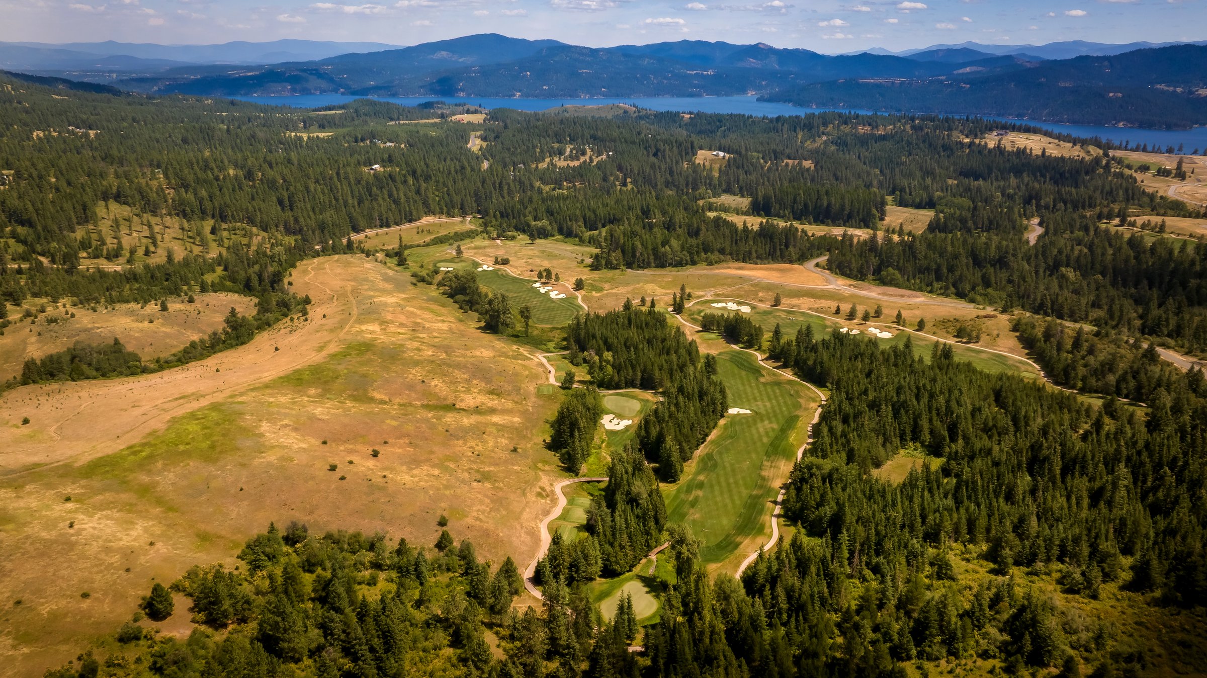 Custom acreage homesite with golf and mountain views at The Ranches at CDA National